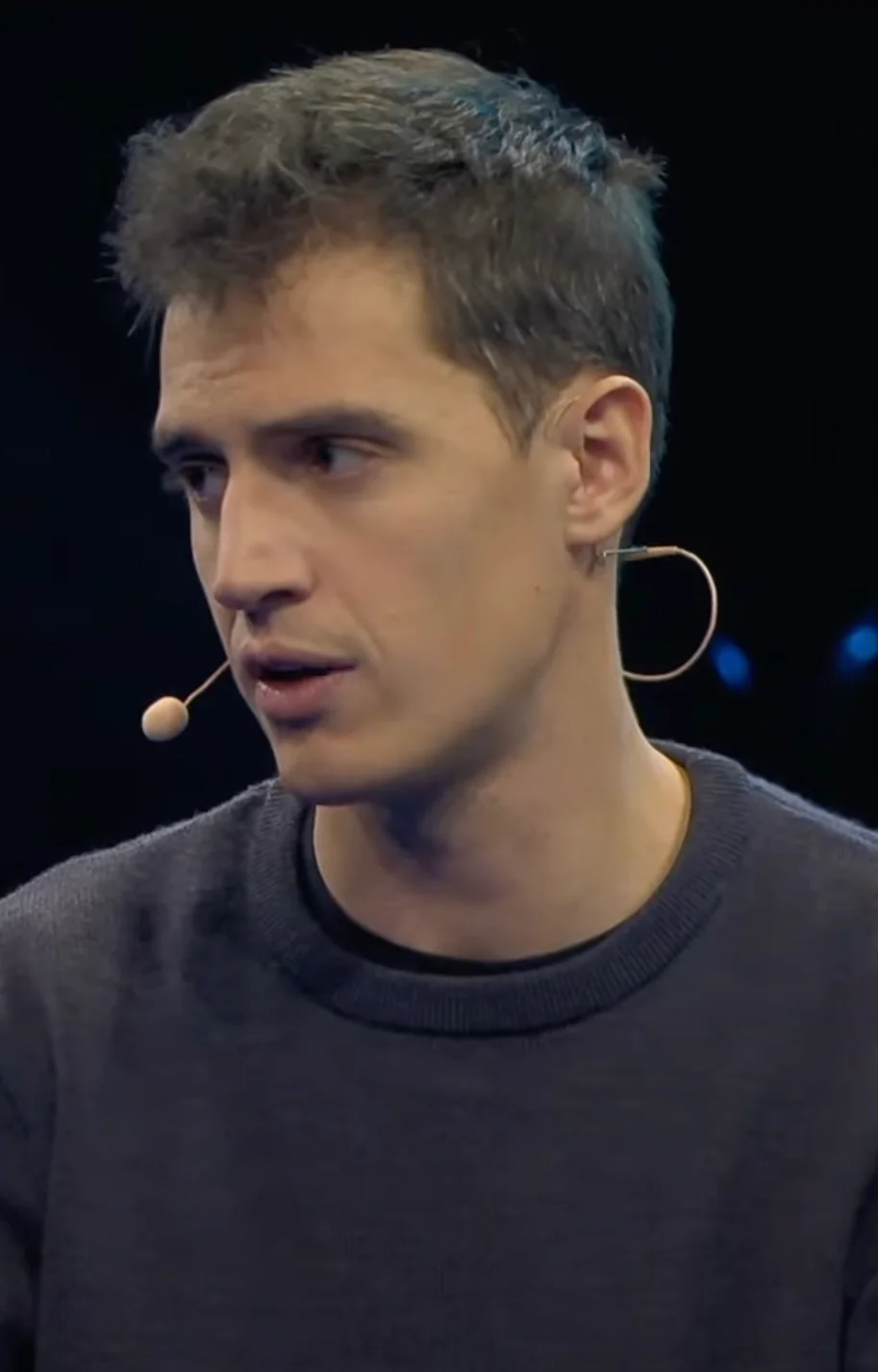 Arthur Mensch speaking with a headset microphone in a video published by Slush