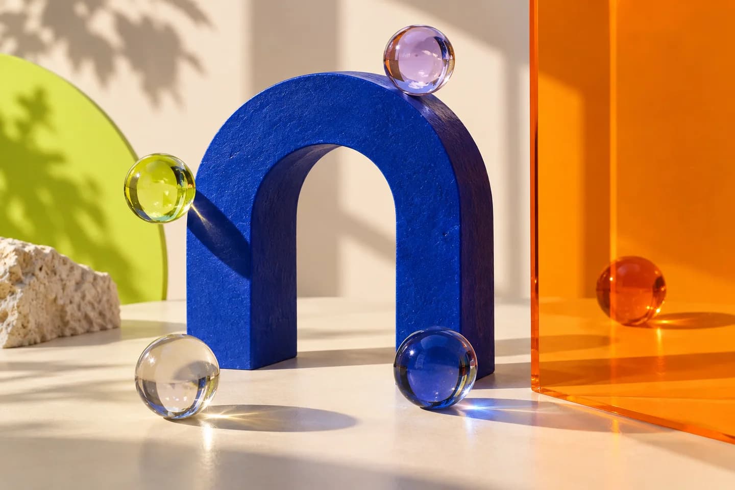 Glass spheres around a cobalt arch, with one beyond a translucent orange partition